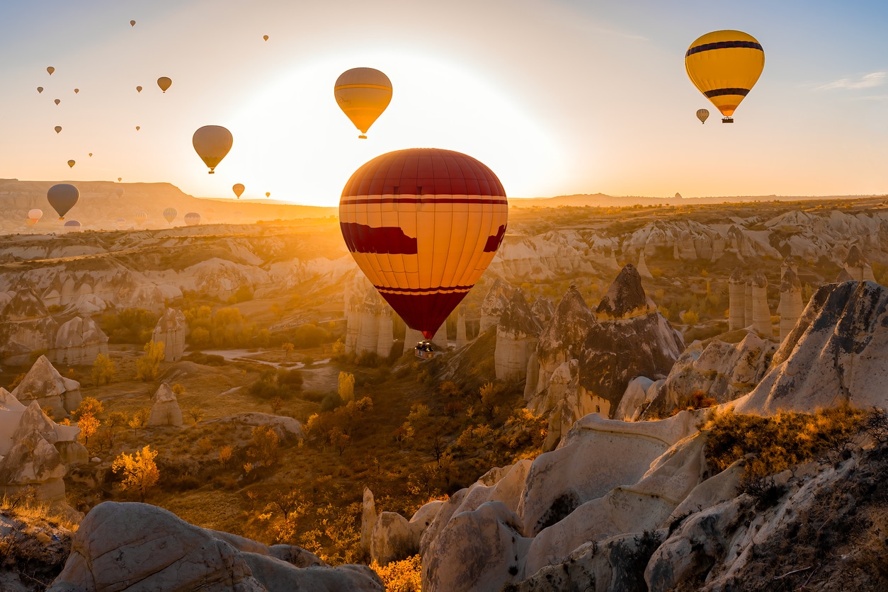 Hot air balloons flying over Cappadocia at sunrise, Turkey