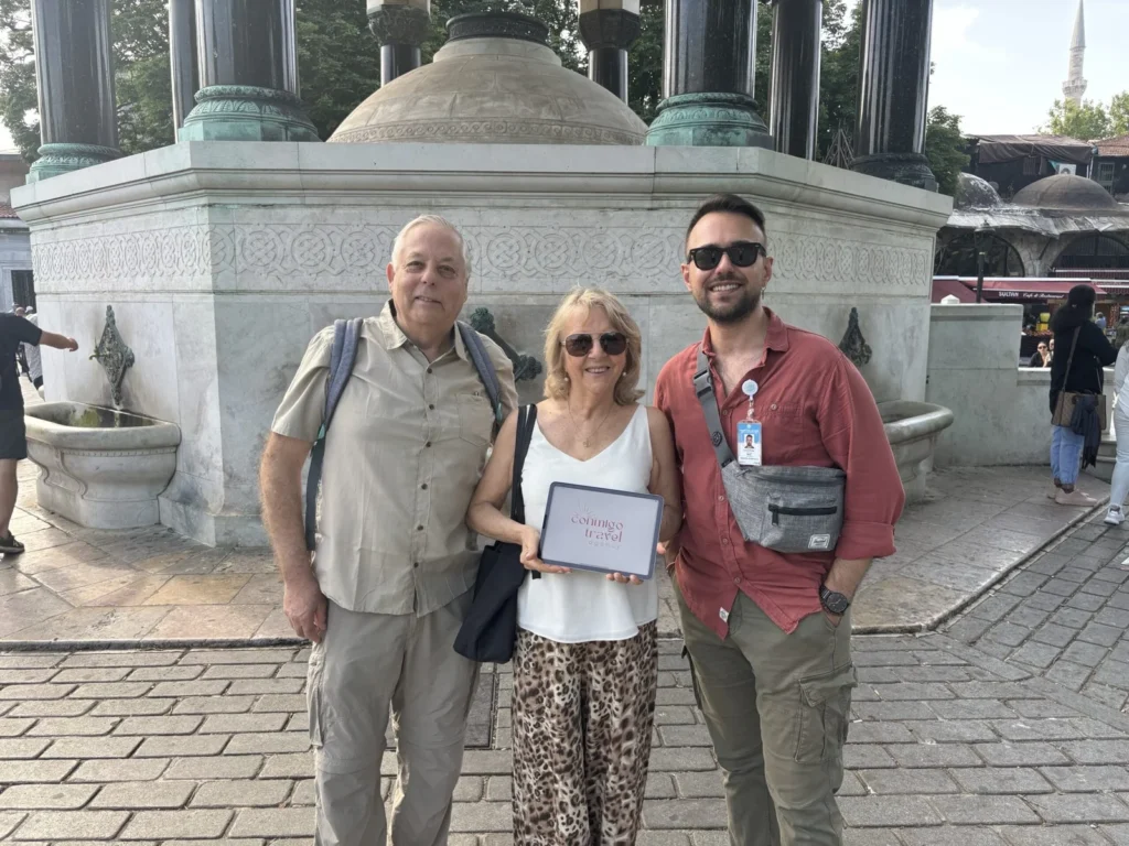 Couple with Conmigo Travel guide near Blue Mosque fountain, Istanbul