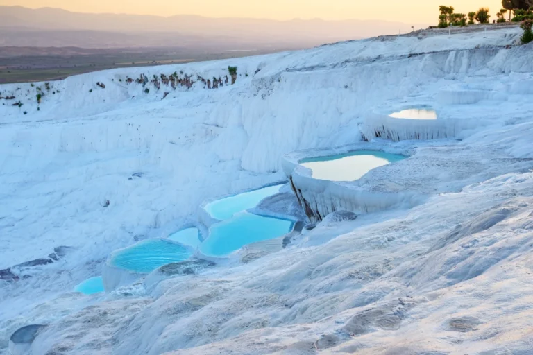 Pamukkale travertine terraces glowing at sunset