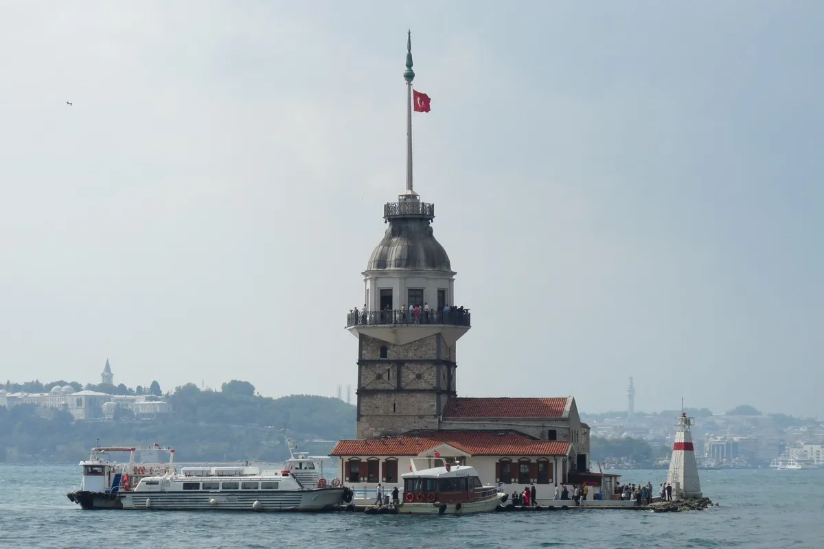 The Maiden Tower (Kiz Kulesi) on a small islet in the Bosphorus with Istanbul skyline behind