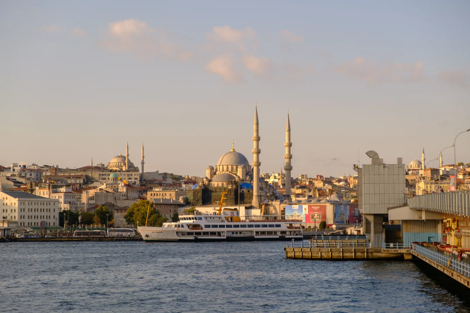 The Eminönü waterfront in Istanbul with ferries docked and the Yeni Cami and Süleymaniye mosques behind