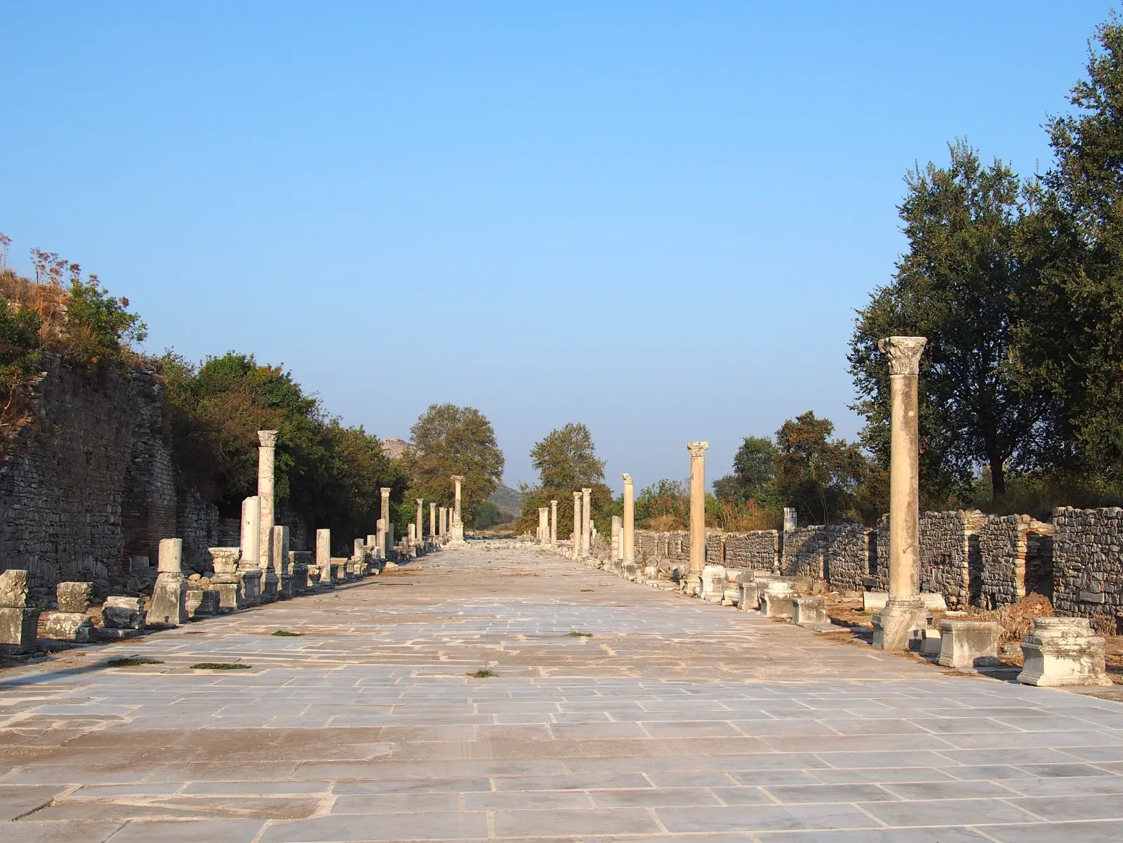 Harbor Street leading to the Great Theater at Ephesus with marble columns lining the ancient avenue