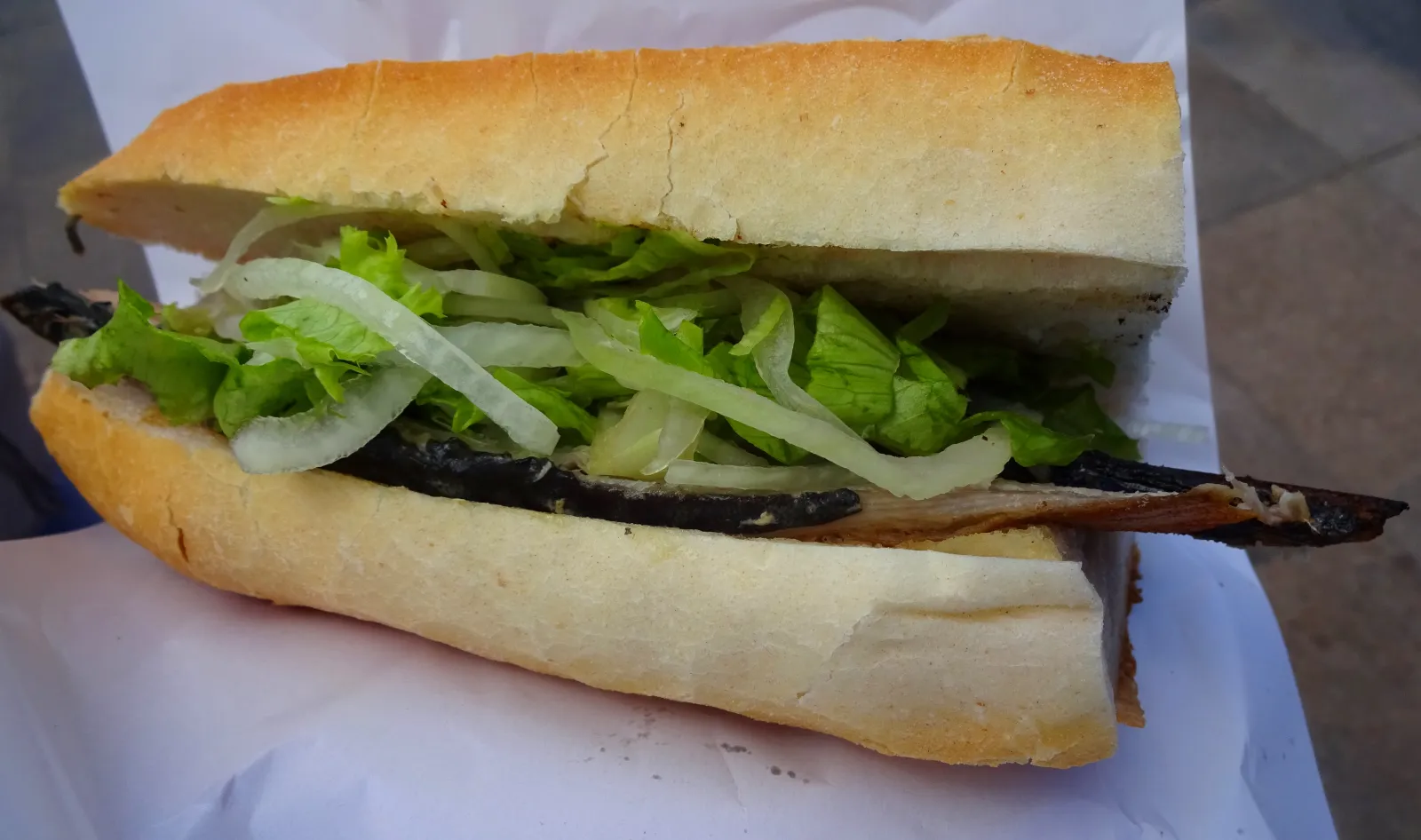 Fish sandwich boats at the Galata Bridge in Istanbul with the bridge and fishermen in the background