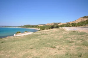ANZAC Cove beach on the Gallipoli Peninsula with steep cliffs rising above the narrow shoreline
