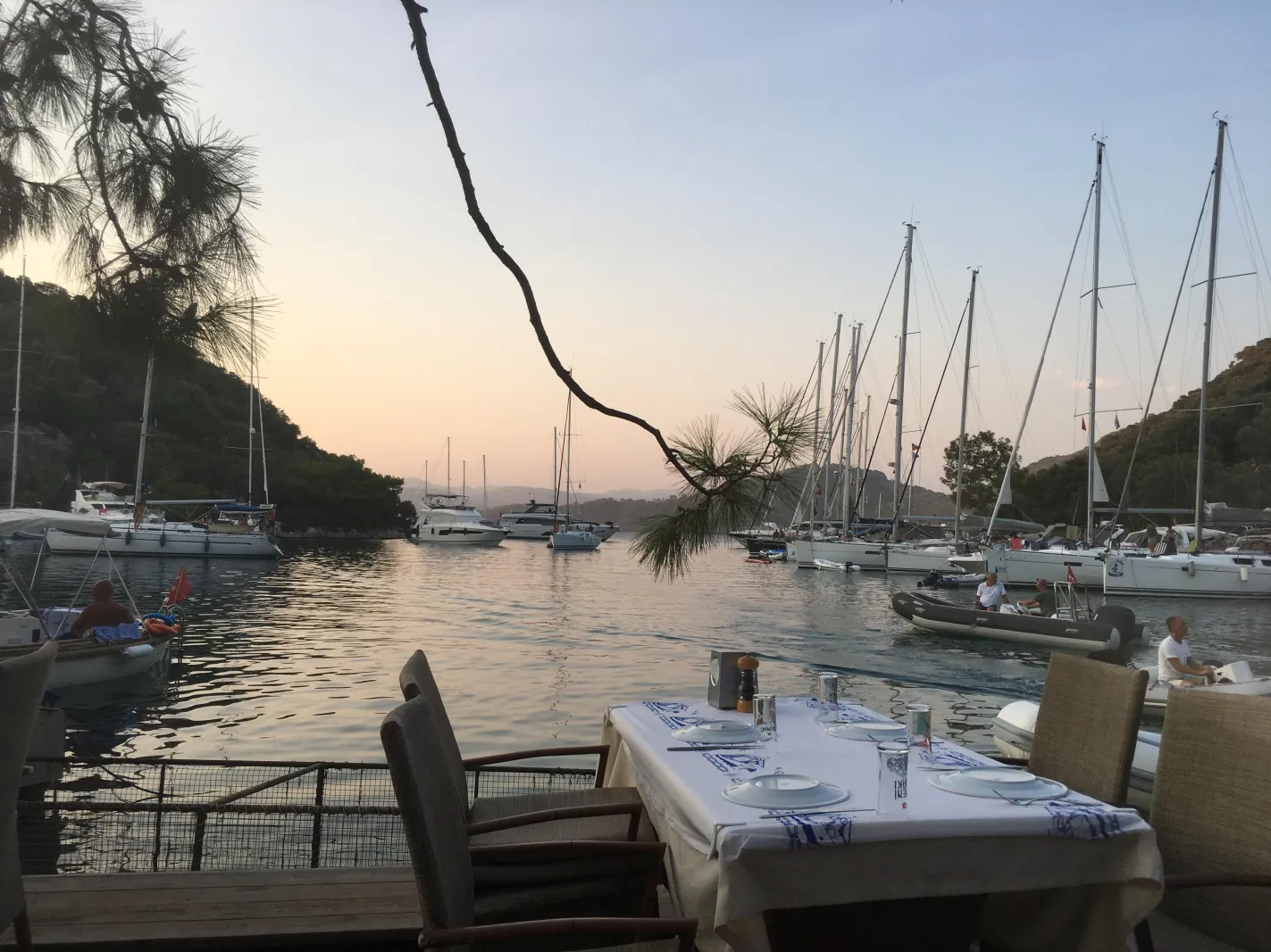 Boats anchored in a sheltered cove at Gobun Island near Gocek at sunset
