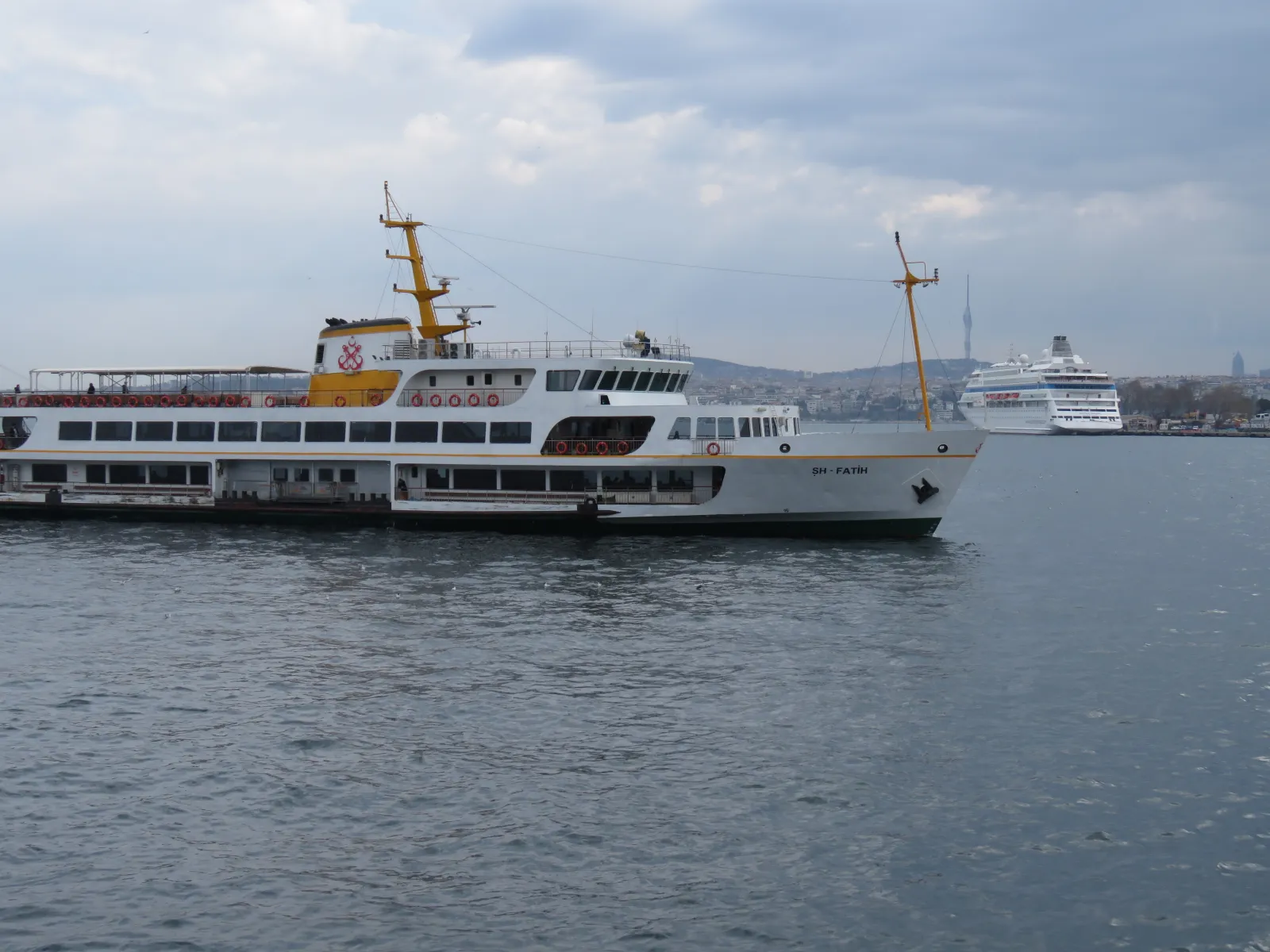 A commuter ferry crossing the Golden Horn in Istanbul with mosques and minarets on both shores