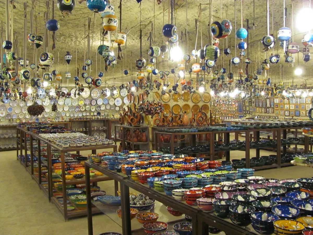 Handpainted Turkish ceramic plates and bowls displayed in a bazaar shop