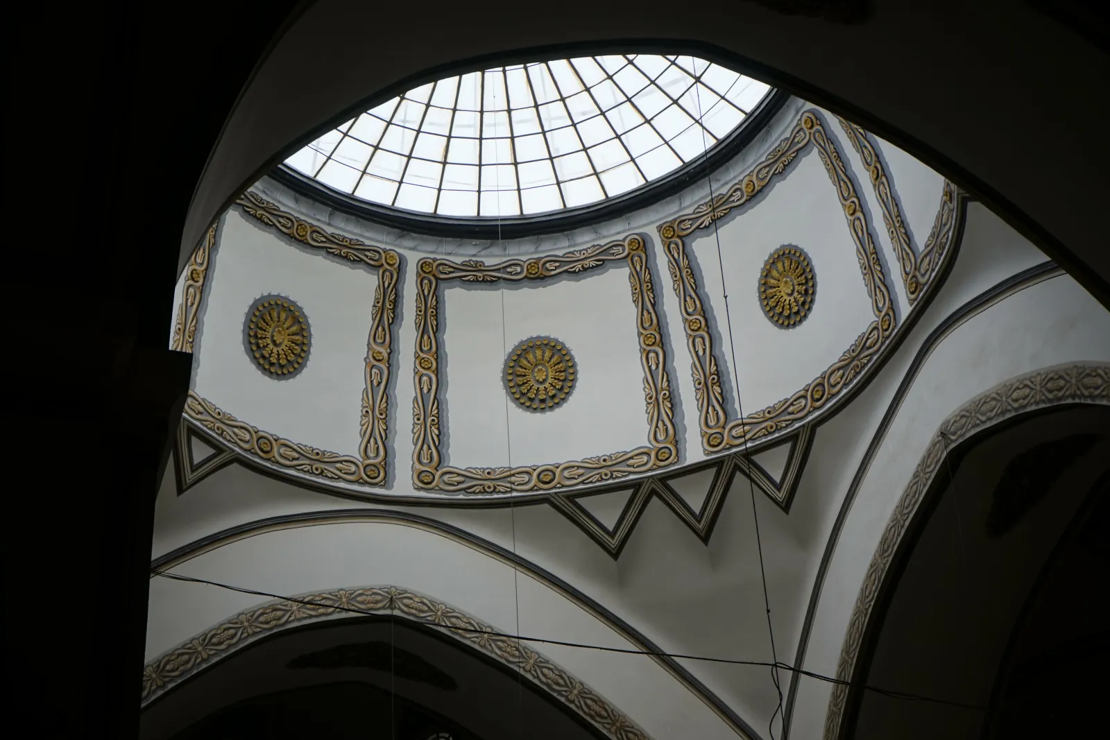 Close view of a dome with its oculus inside the Grand Mosque Bursa showing interior decoration