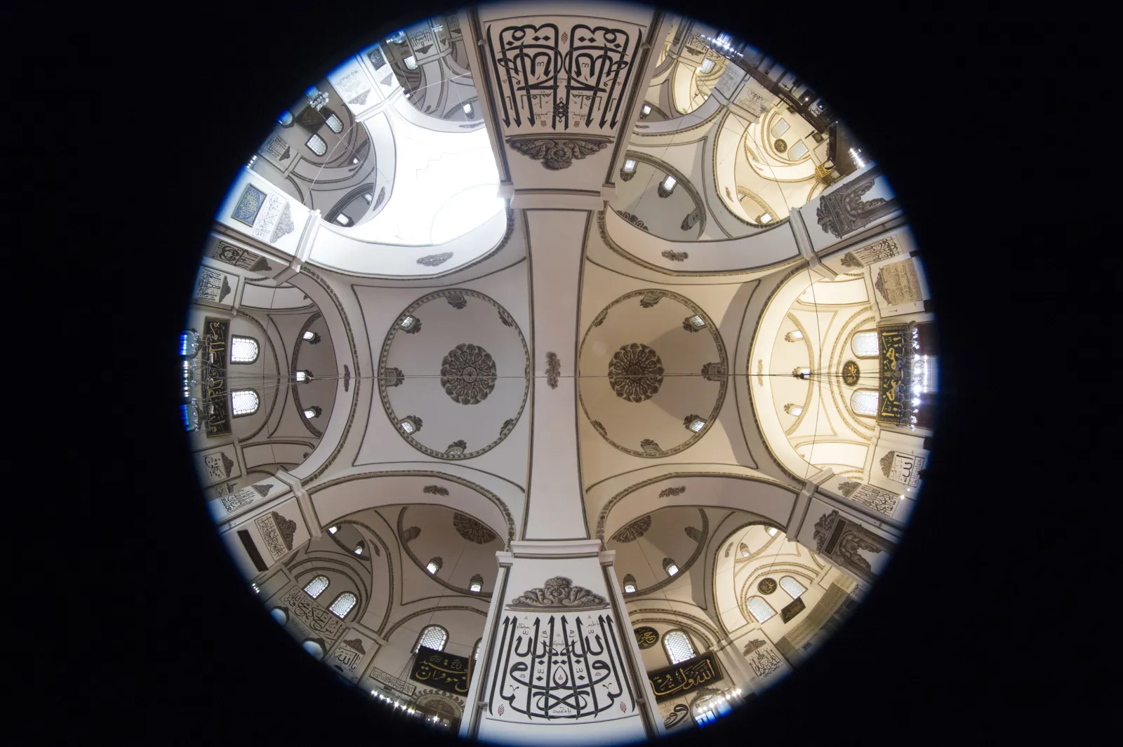 Interior of the Grand Mosque Bursa showing multiple domes and stone pillars