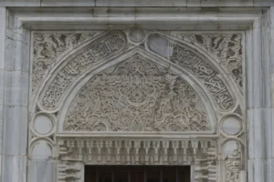Interior of the Green Mosque Bursa showing turquoise Iznik tile panels and mihrab