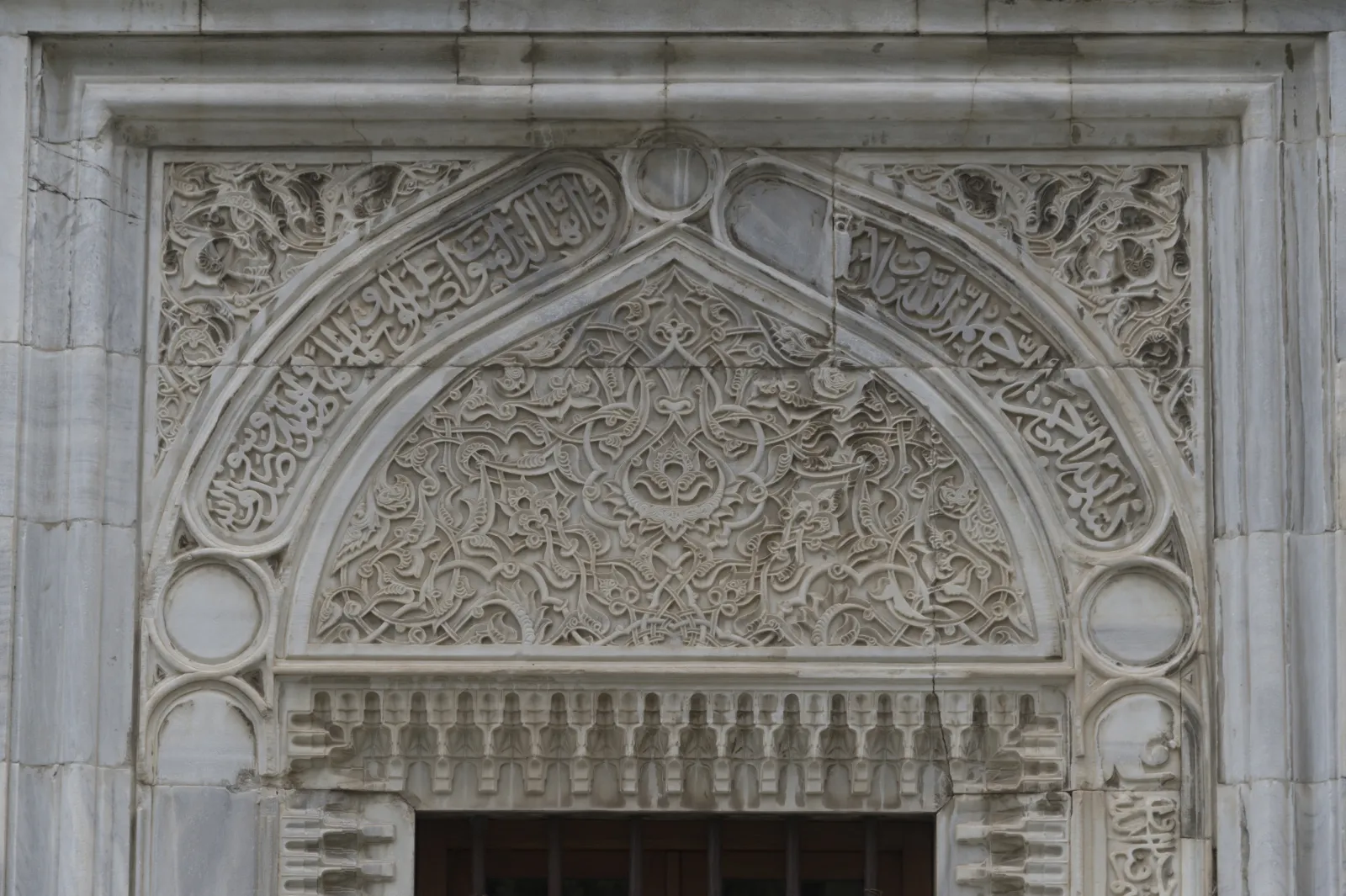 Interior of the Green Mosque Bursa showing turquoise Iznik tile panels and mihrab