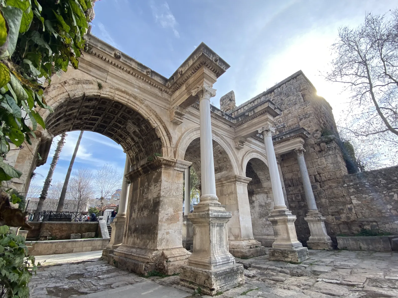 Front view of Hadrian's Gate in Antalya showing the three arched openings and white marble facade