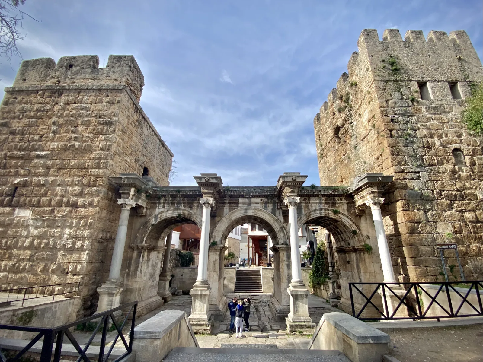 Hadrian's Gate in Antalya flanked by two historic towers integrated into the old city walls
