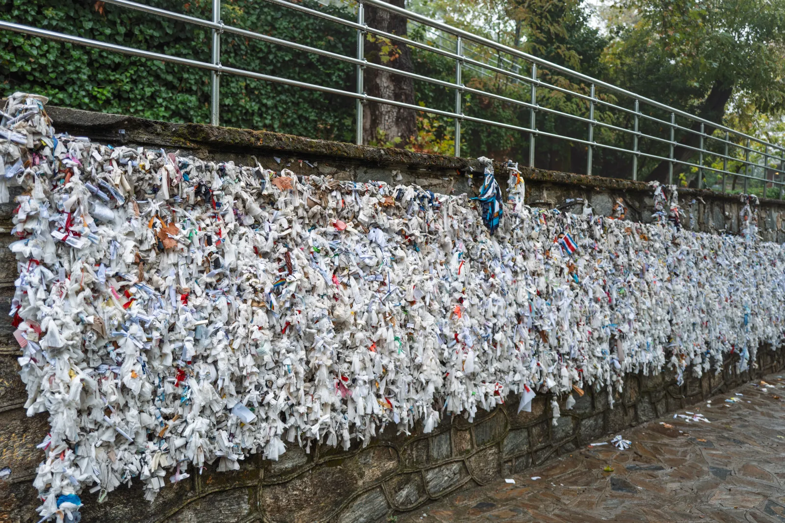 The wishing wall at Meryemana covered with paper notes and cloth strips near the House of the Virgin Mary