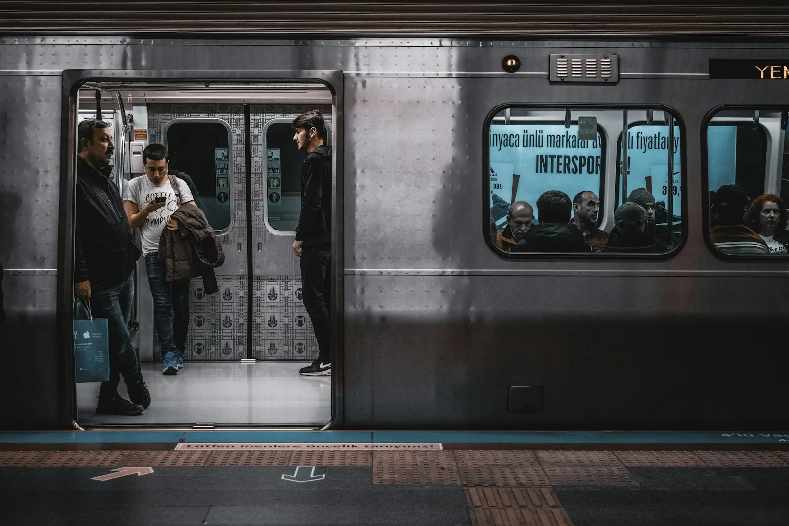 A solo woman waiting beside the T1 tram in Istanbul