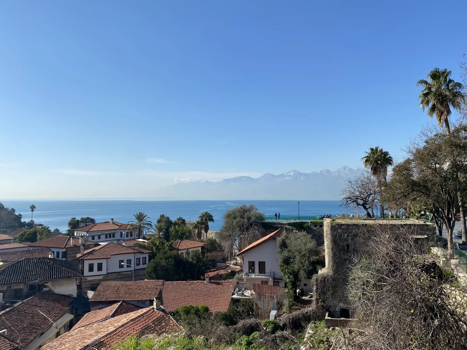 The old harbor of Kaleici Antalya with boats moored in turquoise water and the old town rising above