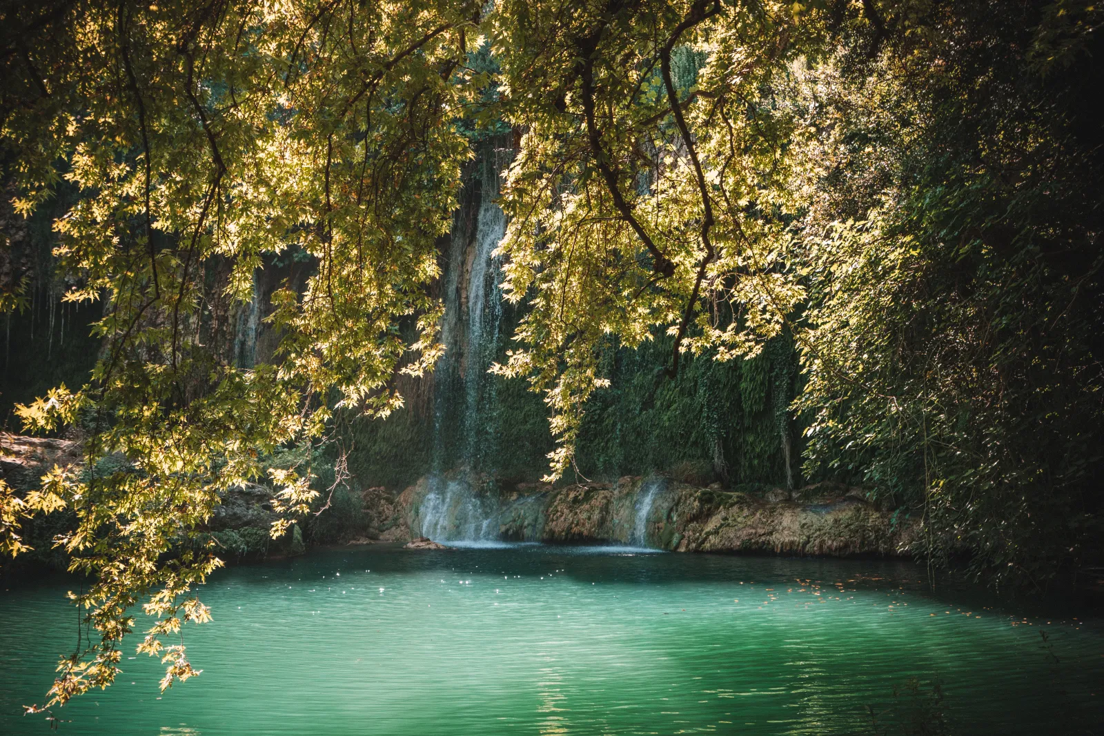 Close view of the Kursunlu waterfall cascading over rocks with lush vegetation in Antalya