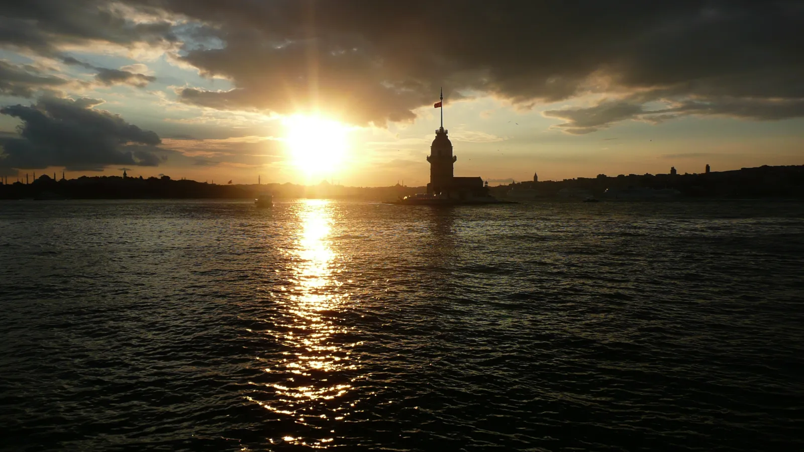 Maiden's Tower silhouetted against a sunset over the Bosphorus in Istanbul