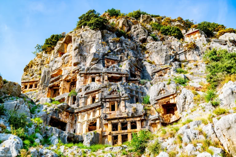 Lycian rock tombs carved into the cliff face at ancient Myra in Demre, showing temple-facade architecture stacked in rows