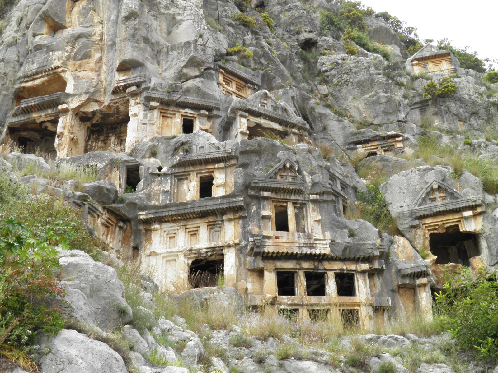 Close-up of a Lycian rock tomb facade at Myra showing carved columns and relief panels