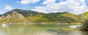 Aerial view of Oludeniz Blue Lagoon showing turquoise water, sand bar, and surrounding pine forest