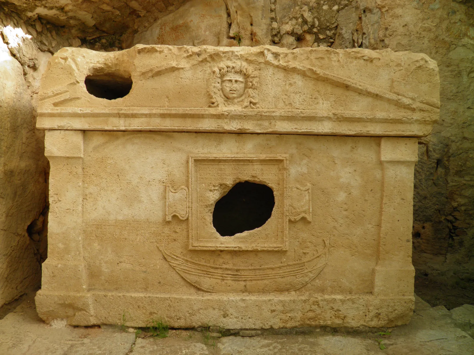 Ancient Lycian ruins at Olympos with stone walls half-buried in forest vegetation