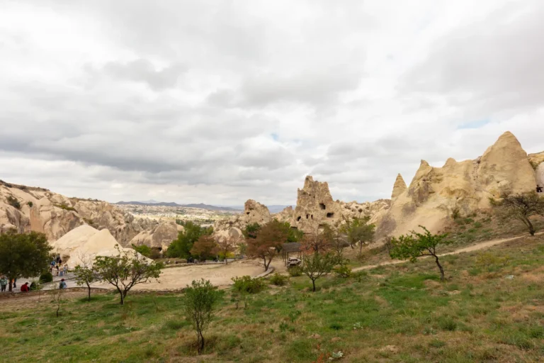 Tall mushroom-shaped fairy chimneys at Pasabag Monks Valley in Cappadocia with visitors walking below