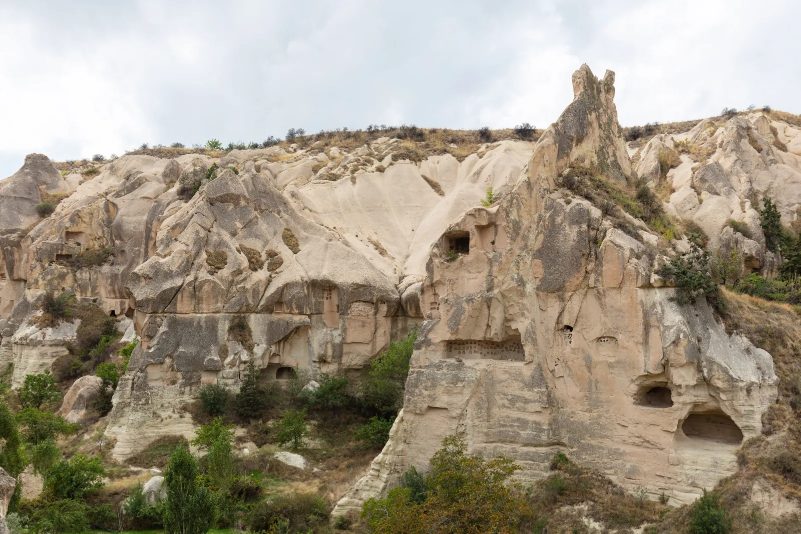 Close view of a fairy chimney at Pasabag Cappadocia showing carved cell openings in the rock