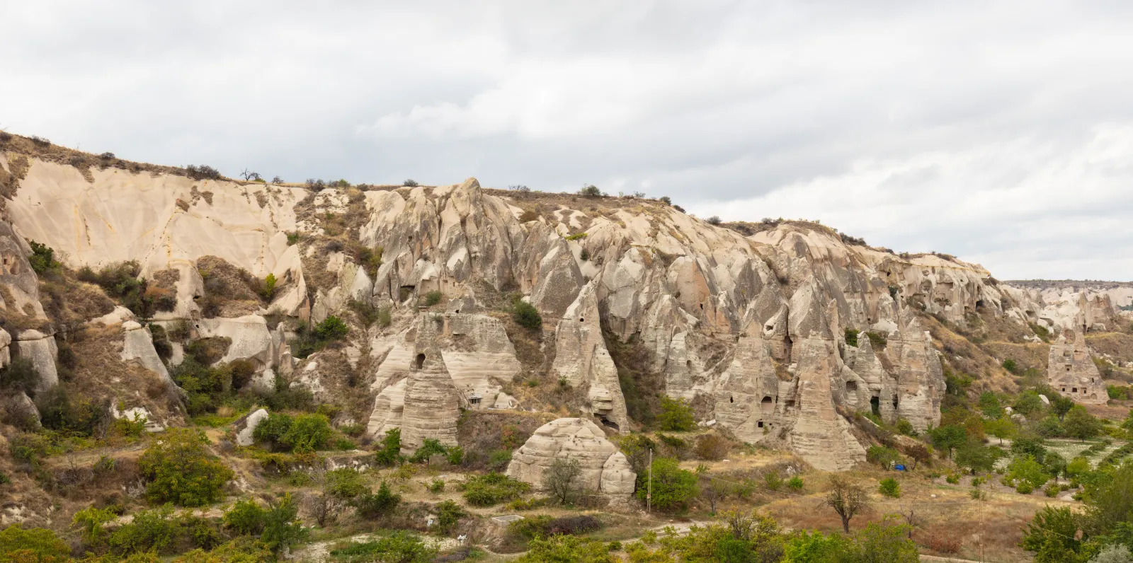 Panoramic view across Pasabag Monks Valley in Cappadocia with tall fairy chimneys and vineyards