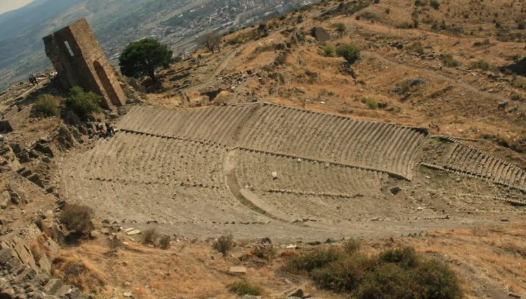 The steep theater of Pergamon carved into the hillside with the plain of Bergama far below