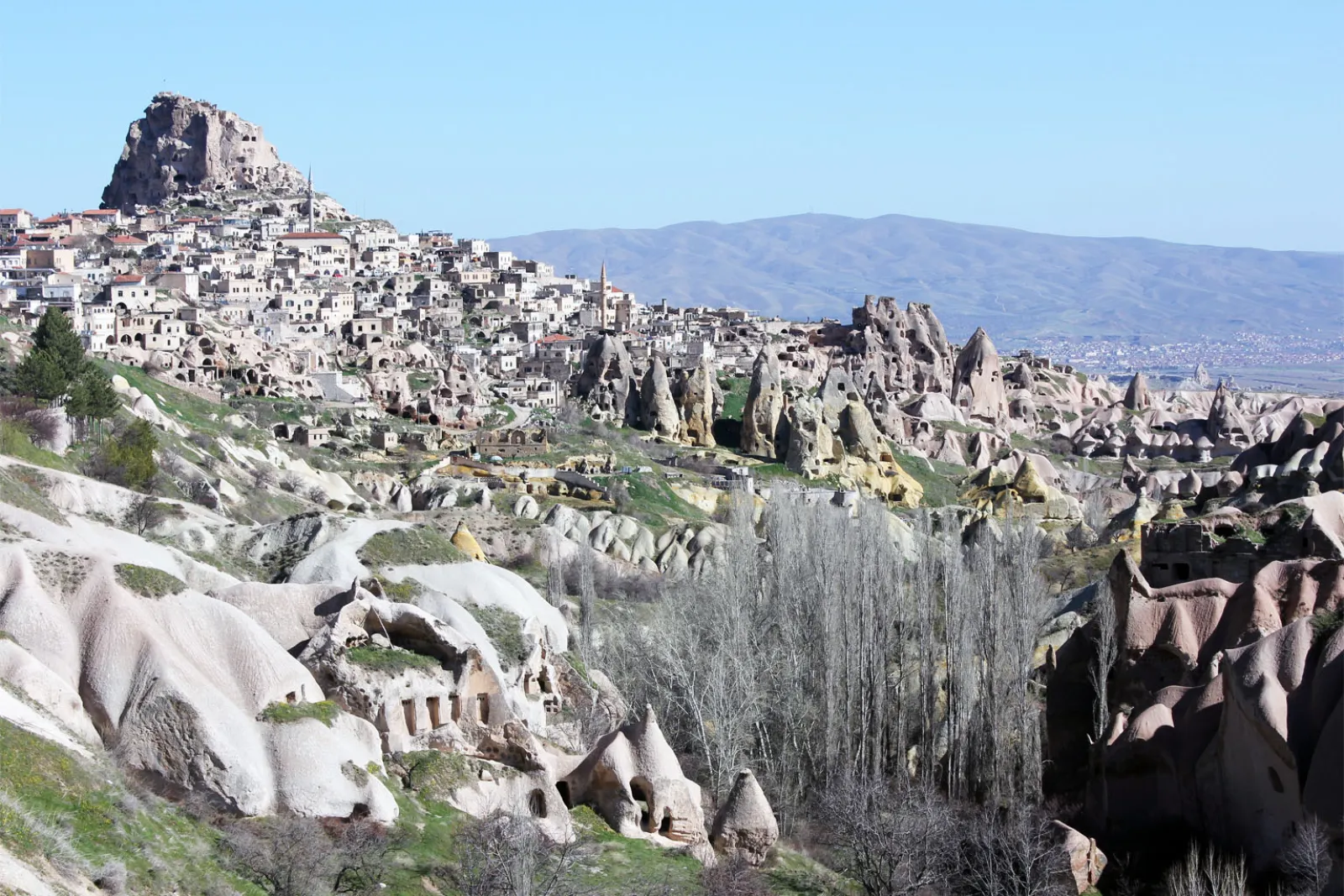 Troglodyte dwellings and carved cliff faces in Pigeon Valley Cappadocia with dovecotes visible in the rock