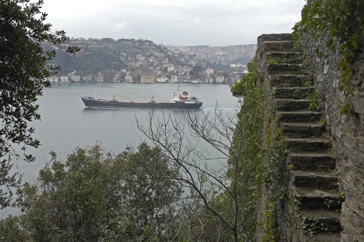 View from Rumeli Fortress walls with stone steps overlooking a ship passing through the Bosphorus