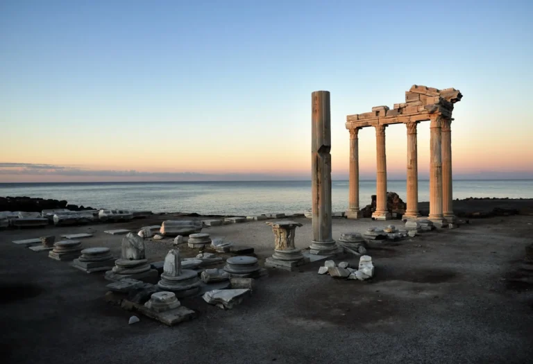 Five remaining columns of the Temple of Apollo in Side silhouetted against the Mediterranean at sunset