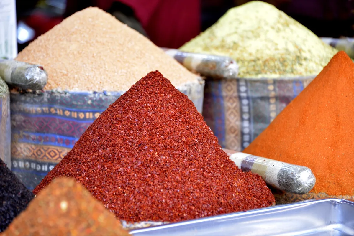 Colorful spice displays with pyramids of ground spices at the Spice Bazaar Istanbul