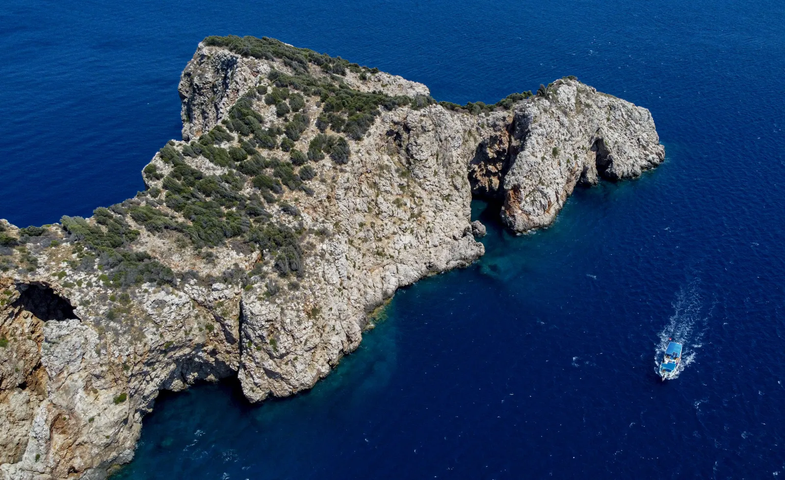 Aerial view of Suluada Island near Adrasan with turquoise water and boats anchored offshore