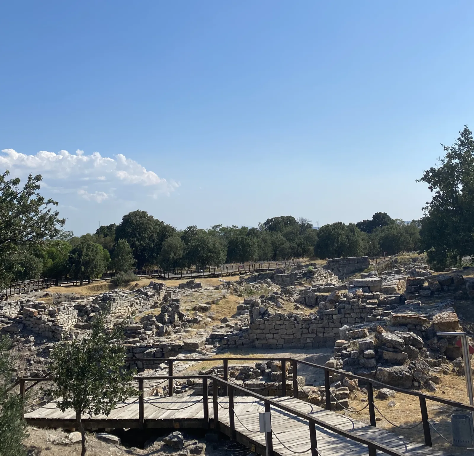 A view from the Troy ancient city archaeological site with stone ruins and trees