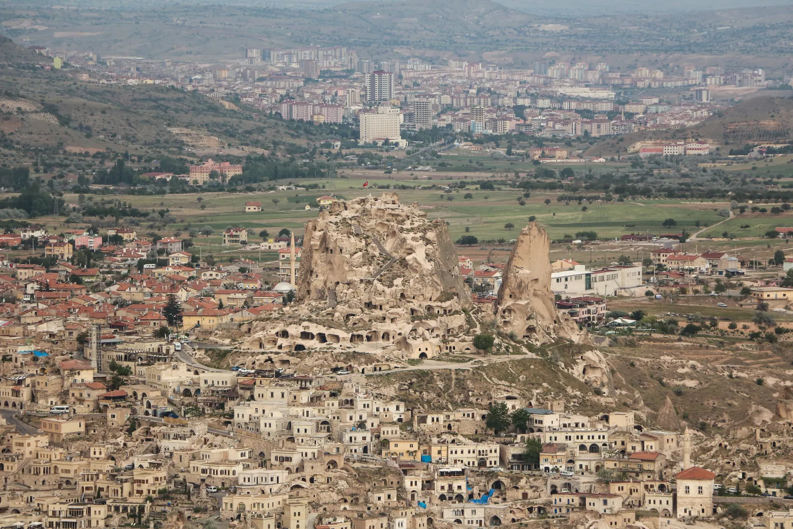 Aerial view of Uchisar Castle and village in Cappadocia with cave-carved rock formations
