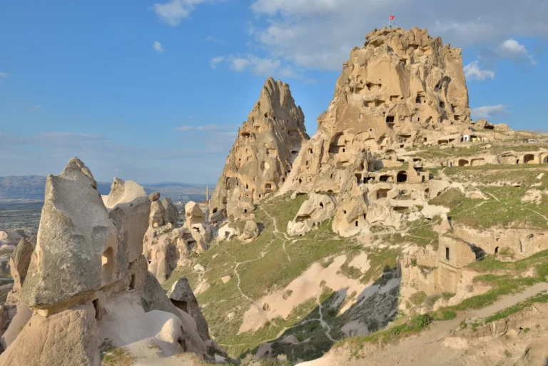 Uchisar Castle rock formation rising above the village in Cappadocia with cave dwellings visible in its face
