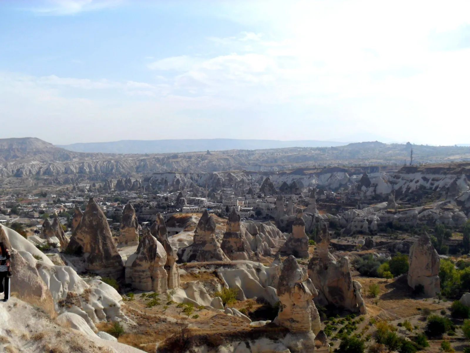 Panoramic view of Goreme village surrounded by fairy chimney rock formations in Nevsehir Province, Cappadocia