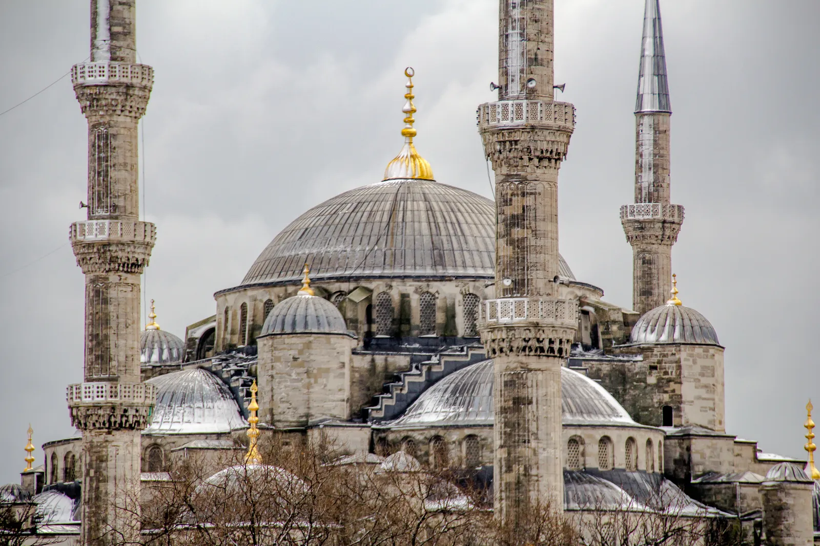 Visitors inside a Turkish mosque dressed respectfully with covered shoulders and headscarves