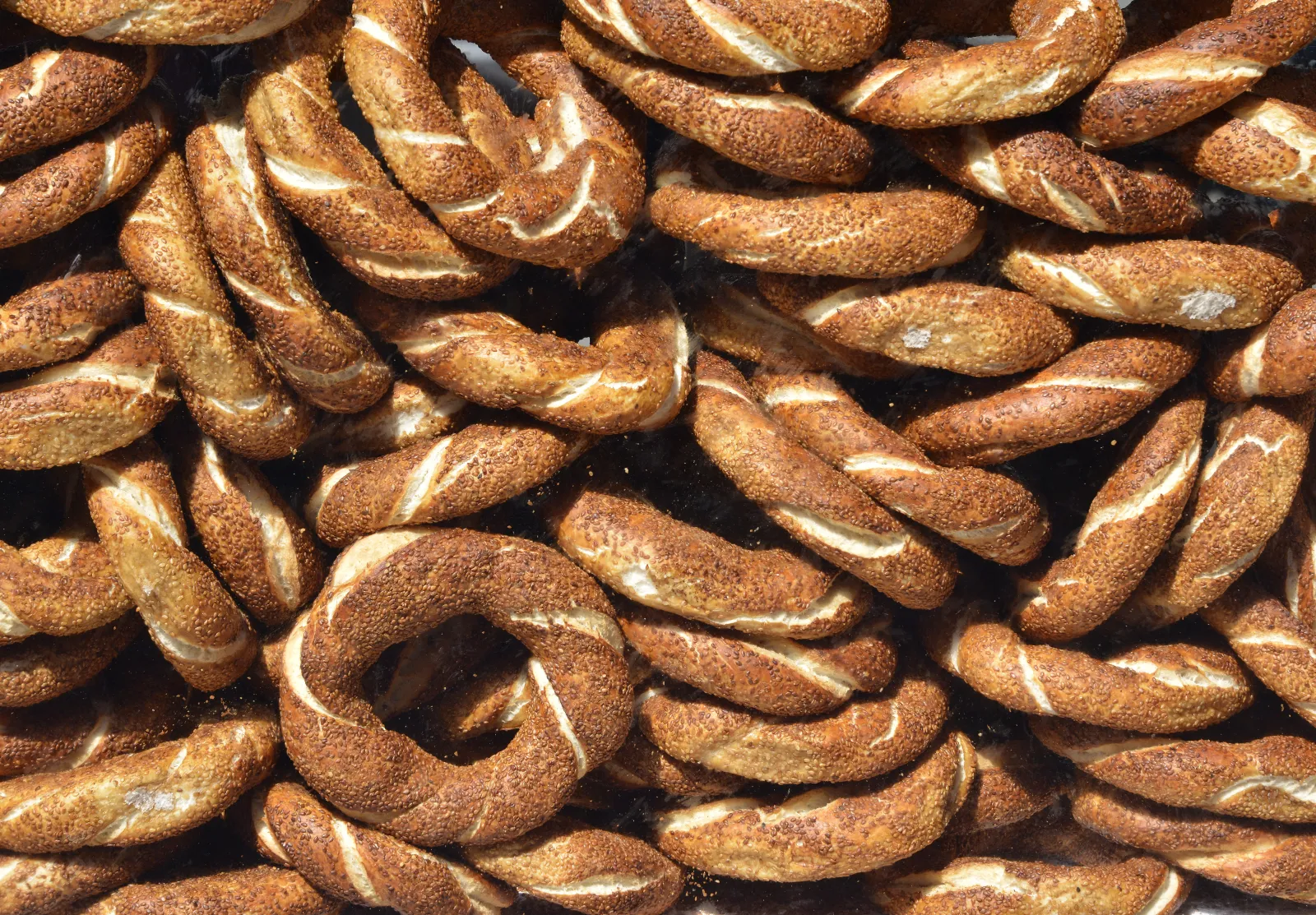 A street vendor selling simit sesame bread rings from a red cart in Istanbul